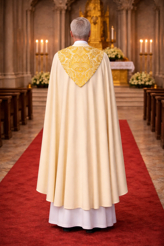 Priest in a white alb with a ivory and gold cope in a church setting
