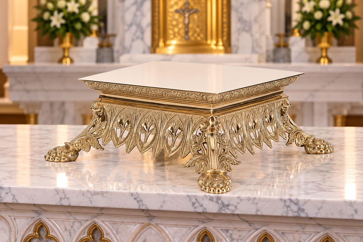 An ornate gold pedestal thabor with a square white marble top, featuring decorative carved legs and lion paw feet, set on a polished white marble surface.