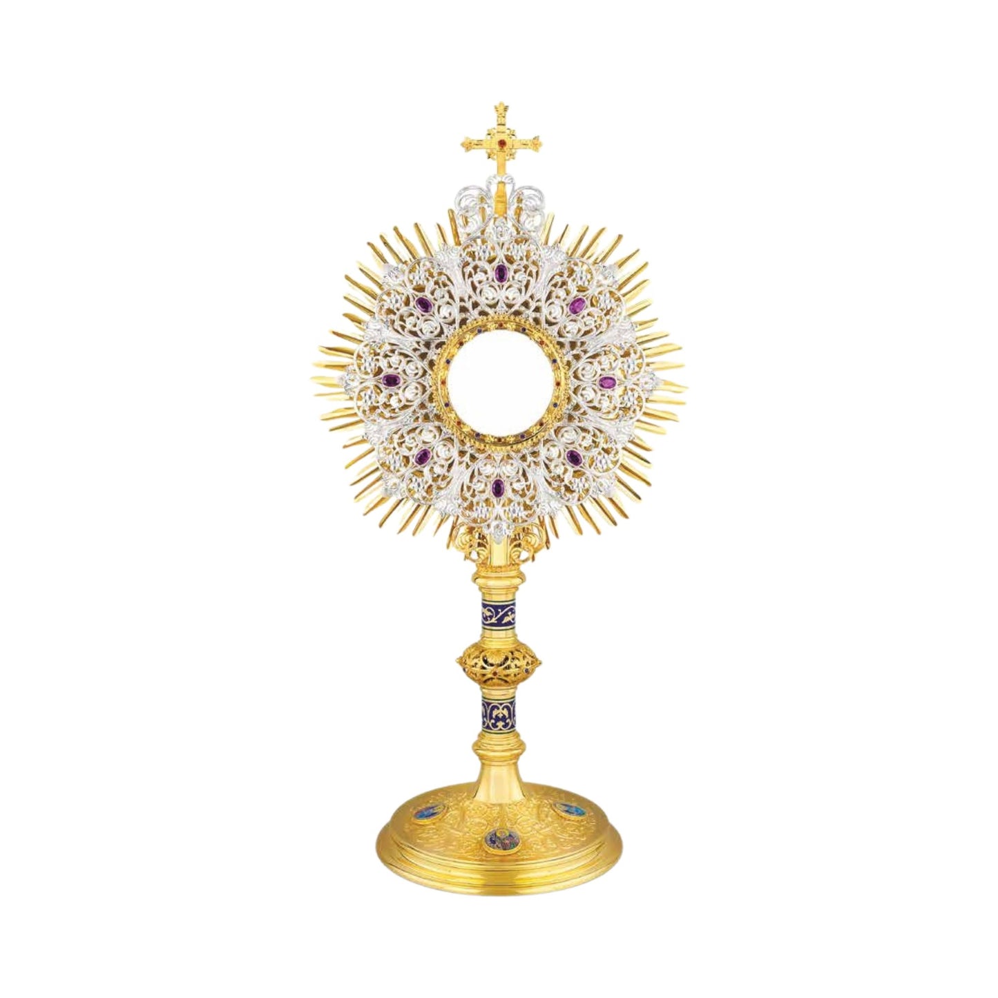 Highly decorated monstrance inspired by original German models from the late XIX and early XX centuries. Multilayered glory consists of a gold-plated sunburst and an elaborate silver-plated wreath with synthetic amethysts. The opening for the luna is surrounded with a round frame set with colorful stones. The monstrance is topped with a gold-plated cross. Both the node and the base are richly adorned with scrollwork patterns, colorful stones and enameled accents. Medallions on the base feature the Holy Fami