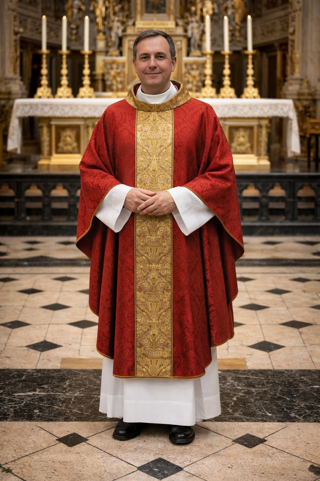 Priest in red and gold vestments standing in a church with an altar in the background.