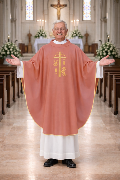 Priest in a church wearing a pink liturgical vestment with a cross emblem.