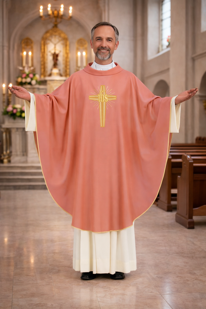 Priest in a pink liturgical vestment with a cross emblem in a church setting