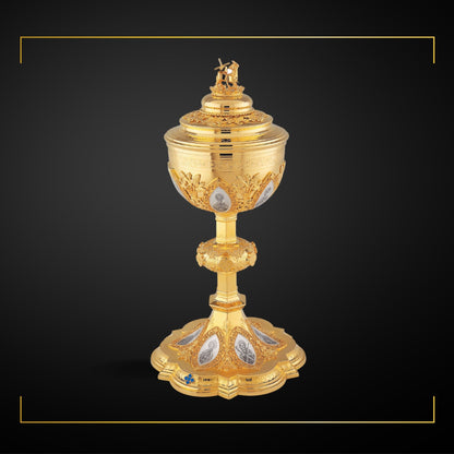 Ciborium in neo-gothic style with medallions of the Twelve Apostles and cup inscription:  “ECCE AGNUS DEI QUI TOLLIT  PECCATA  MUNDI” ,  12” Ht. Sold by The Clergy Store