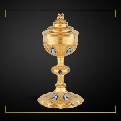 Ciborium in neo-gothic style with enameled medallions of the Twelve Apostles and cup inscription: “ECCE AGNUS DEI QUI 
TOLLIT PECCATA MUNDI” , 12” Ht. 200  Hosts. Sold by The Clergy Store