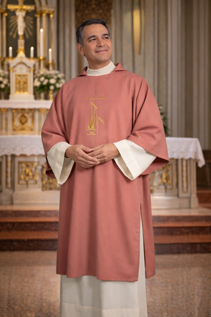 Deacon in a rose liturgical vestment with a cross design, standing in a church setting.