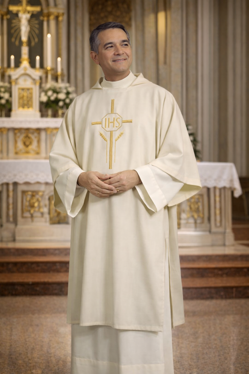 Deacon in ivory dalmatic with IHS symbol in a church setting