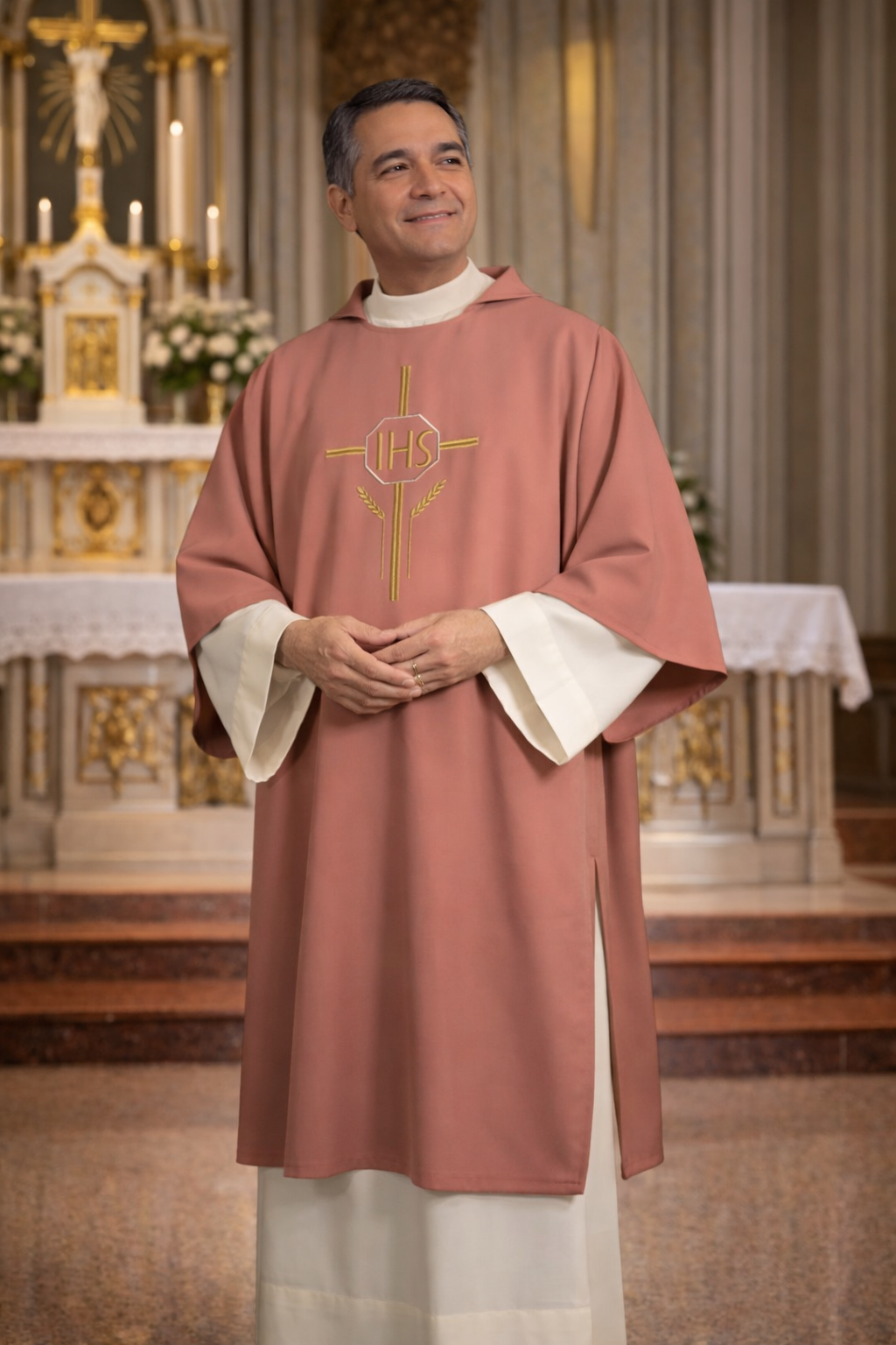 Deacon in a pink liturgical vestment with 'IHS' symbol in a church setting