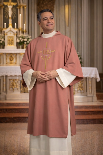 Deacon in a pink liturgical vestment with 'IHS' symbol in a church setting