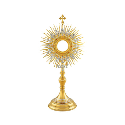 Brass monstrance, 24-karat gold-plated with silver-plated accents. Made in traditional style, which makes it suitable for use in both historical and modern interiors. The sunburst consists of two layers: a layer of gold-plated rays and a silver-plated wreath with flowers. The opening for the luna is surrounded by a decorative pattern encrusted with red stones. The monstrance is topped with a cross. The round base is adorned with a silver-plated floral design.