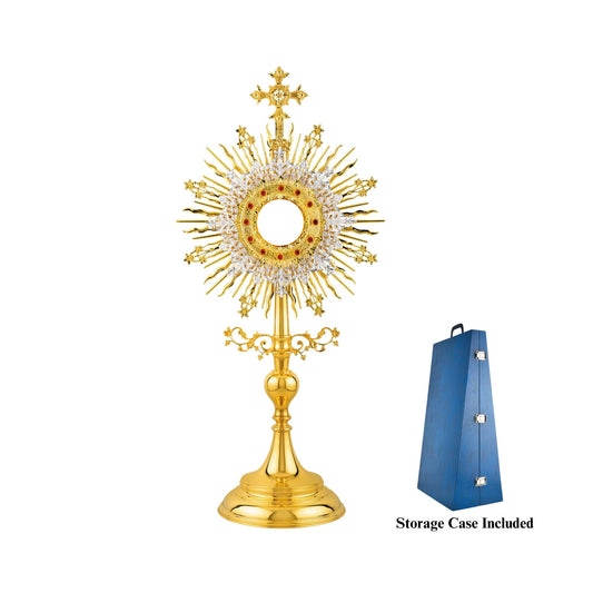 Traditional monstrance made of brass, 24-karat gold-plated with silver-plated accents. The glory is shaped as sunburst adorned with flowers. The luna case is surrounded by a decorative frame encrusted with red stones and a silver-plated floral wreath.