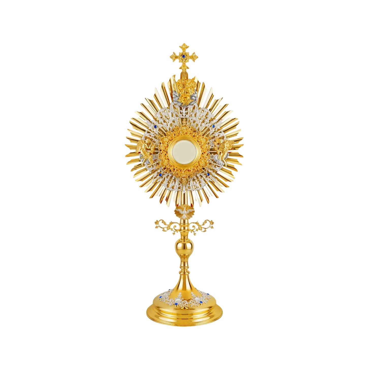 Brass monstrance in traditional style, 24-karat gold-plated with silver-plated accents, decorated with blue stones. The glory consists of three layers: a sunburst and two floral wreaths made of open filigrees. The bigger wreath has figures of God the Father and Jesus attached to the top, and figures of angels placed on both sides of the luna case. Below the sunburst there is an image of the Dove (the Holy Spirit) surrounded by rays.