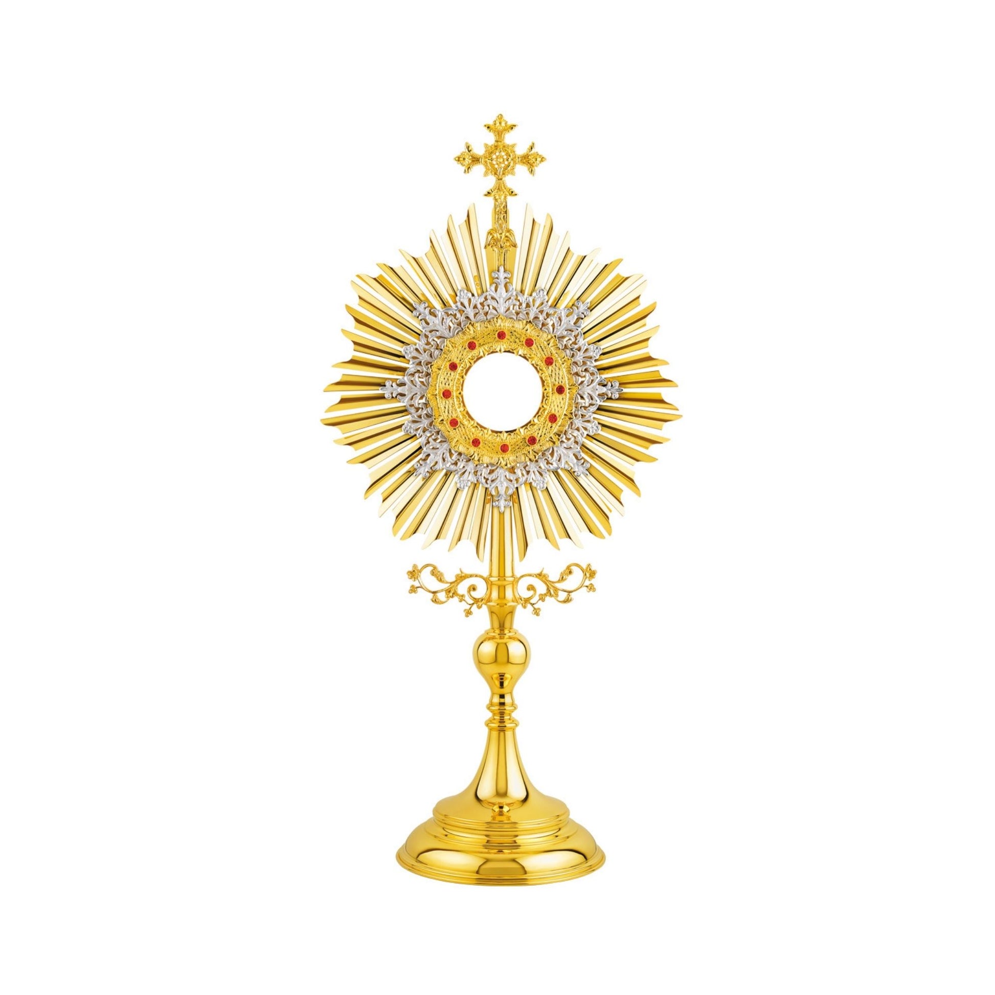 Traditional, sun-shaped monstrance made of brass, 24-karat gold-plated. The luna case is surrounded by a silver-plated floral wreath and a round decorative frame set with red stones. At the top of the monstrance there is a big cross with sculpted ornaments. The node and the base are finished in high gloss.