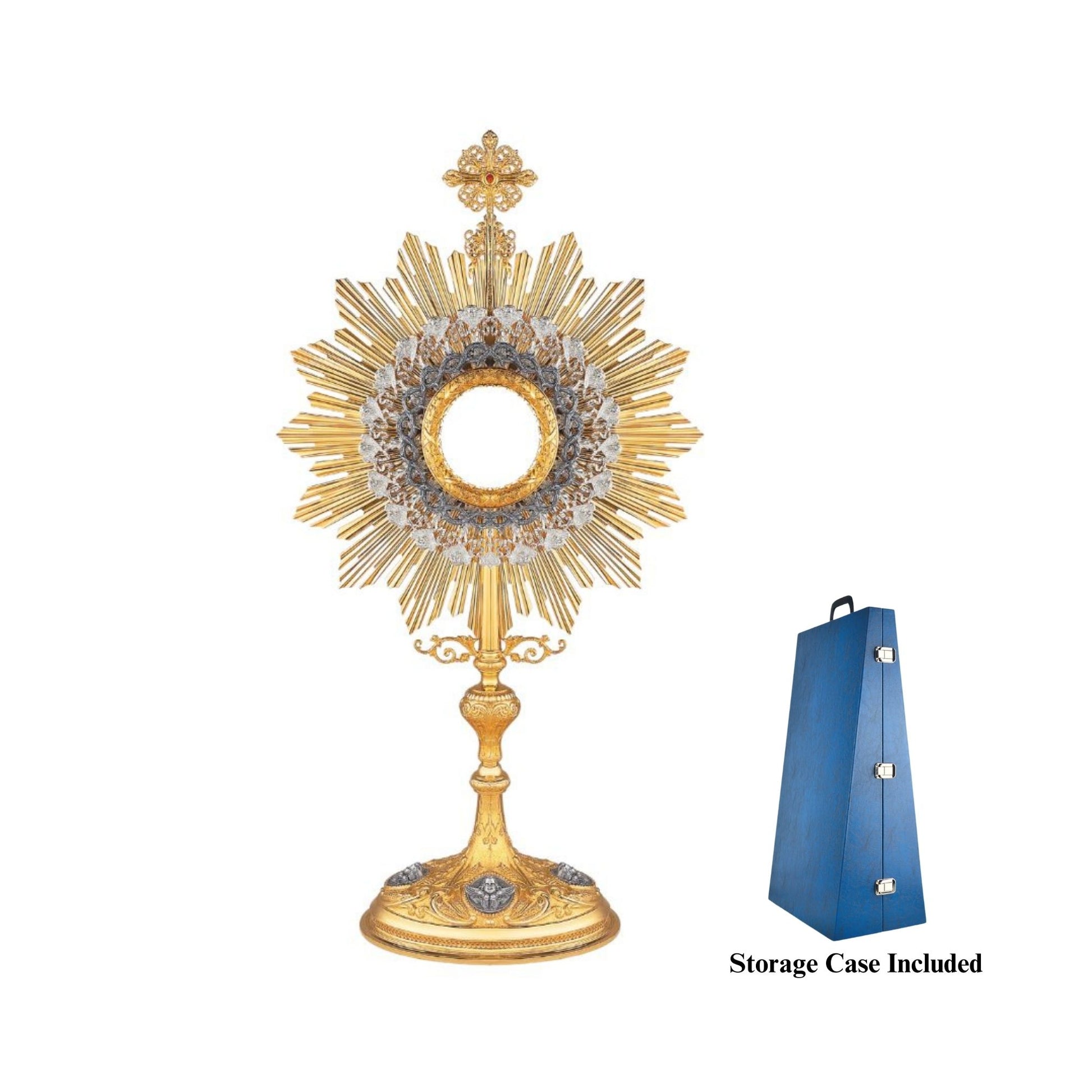Brass monstrance, 24-karat gold-plated with silver-plated accents. The luna case is surrounded with a silver-plated and oxidized layer shaped as a crown of thorns. The cross at the top is adorned with elaborate filigrees and a red gemstone. The base features sculpted medallions depicting angels. This design is based on monstrances from the beginning of the XX century.