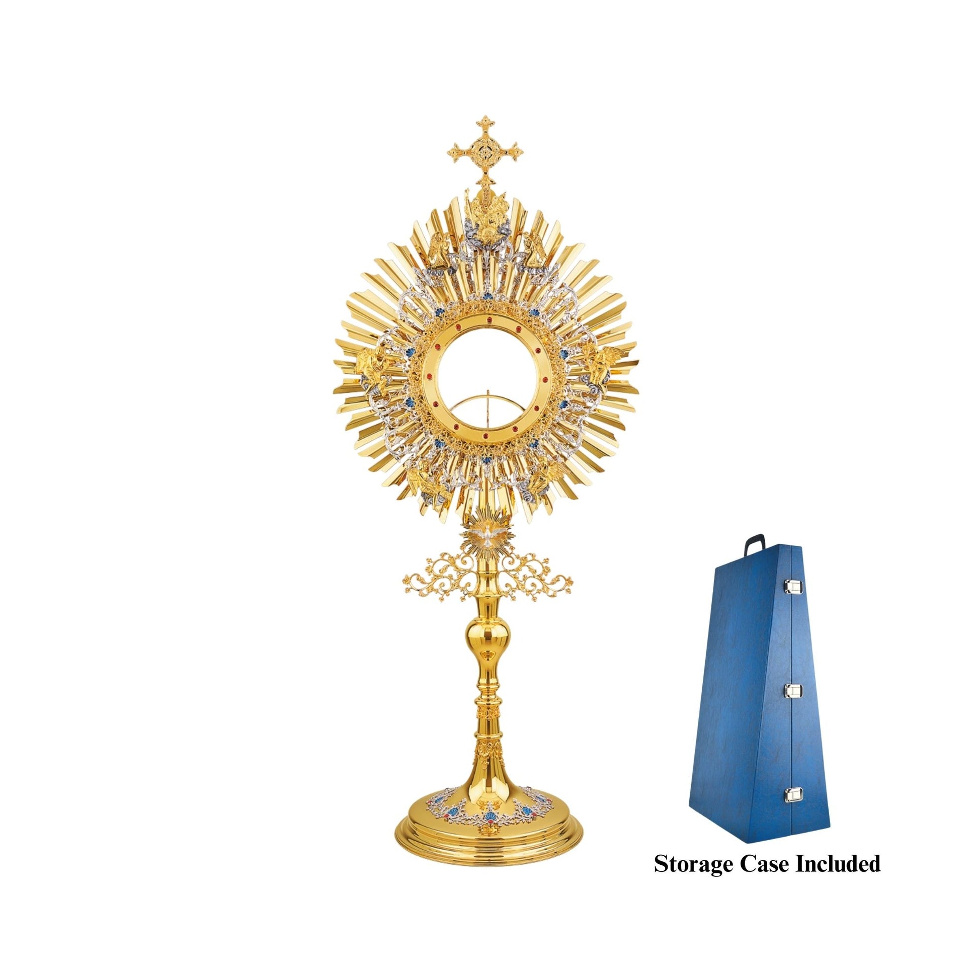 A large monstrance (height: 43-1/4") for a big host (diameter: 6"). Made of brass, 24-karat gold-plated. The glory consists of two sunbursts and two elaborate silver-plated wreaths. The bigger wreath has figures of God the Father and Jesus attached to the top, and six angels placed around the luna case. The smaller wreath is embellished with blue-enameled accents. A figure of the Holy Spirit (the Dove) against its own small sunburst is set at the bottom of the glory. 