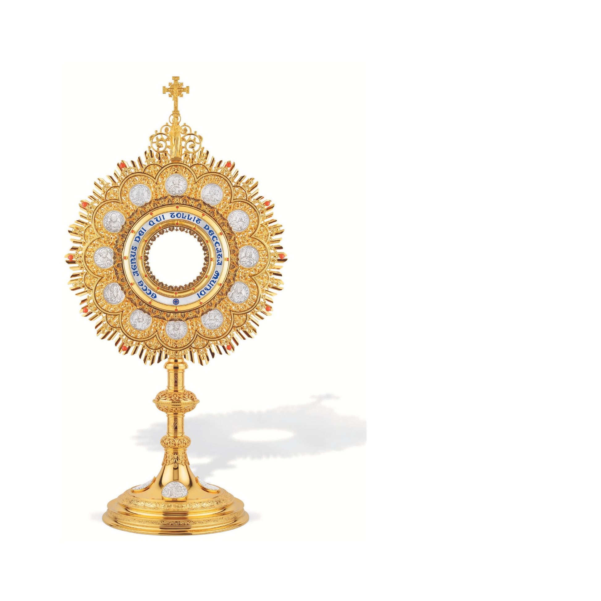 Traditional Monstrance with medallions of the Twelve Apostles and 
Latin inscription: “ECCE AGNUS DEI QUI TOLLIT PECCATA MUNDI”; 
medallions with scenes from the Bible on base. Made in Poland and sold by The Clergy Store