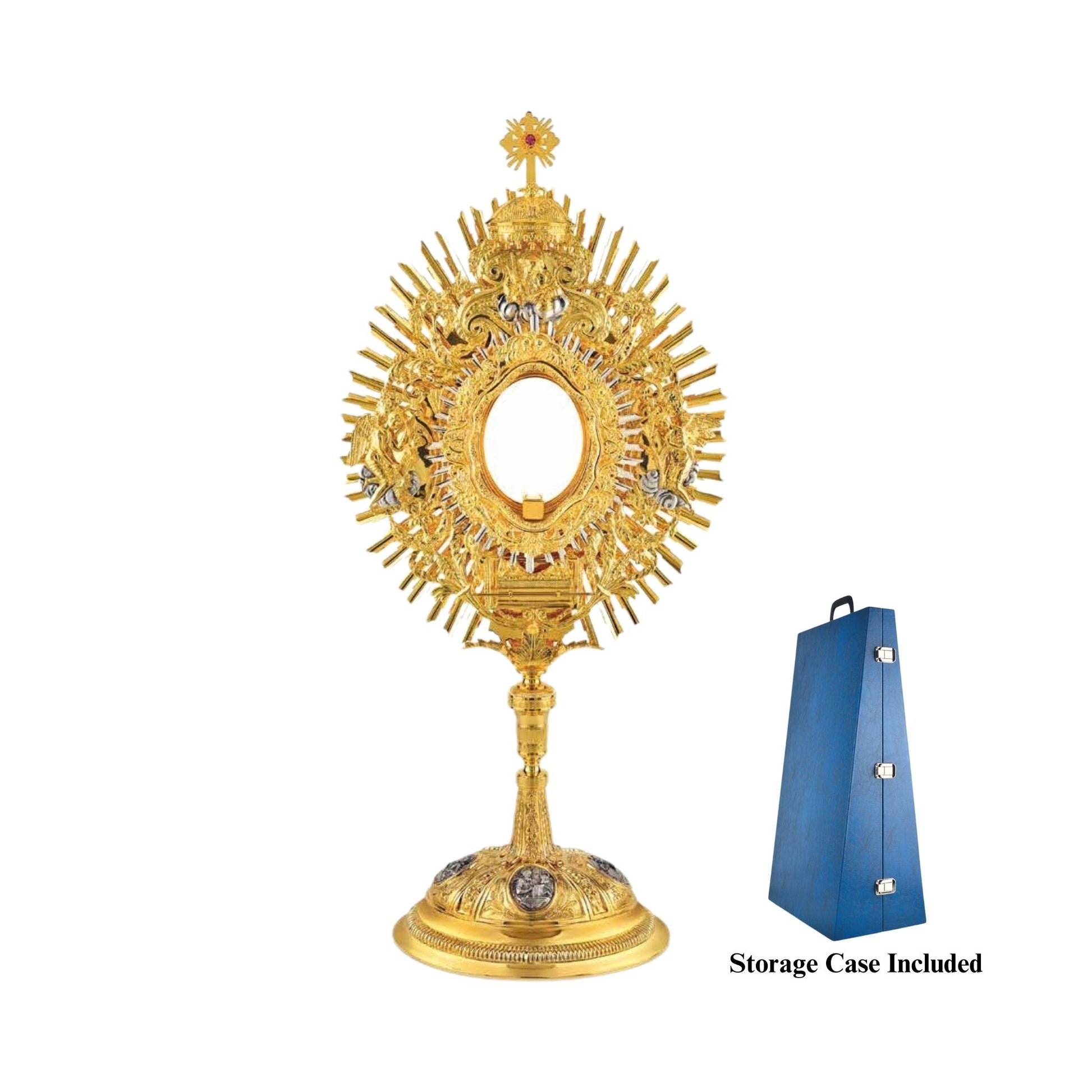 Brass monstrance, 24-karat gold-plated with silver-plated accents. The glory is embellished with an ornate wreath featuring grapevine and wheat motifs, and figures of God the Father, two angels and the Ark of The Covenant. The monstrance is topped with a dome and a cross encrusted with a pink stone. The oval base is decorated with silver-plated medallions of the Evangelists.
