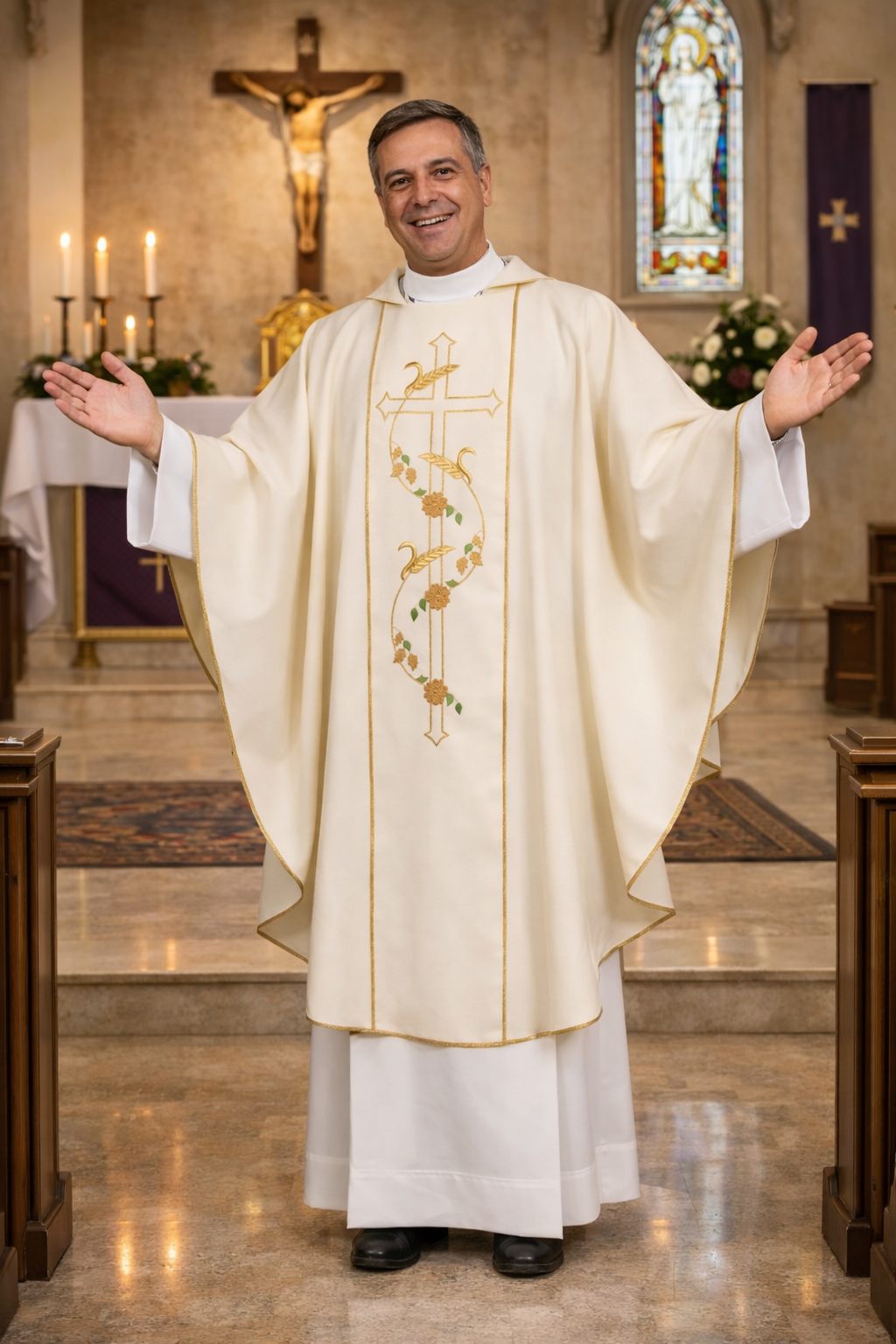 Priest in white liturgical vestments standing in a church with a crucifix and stained glass window in the background.