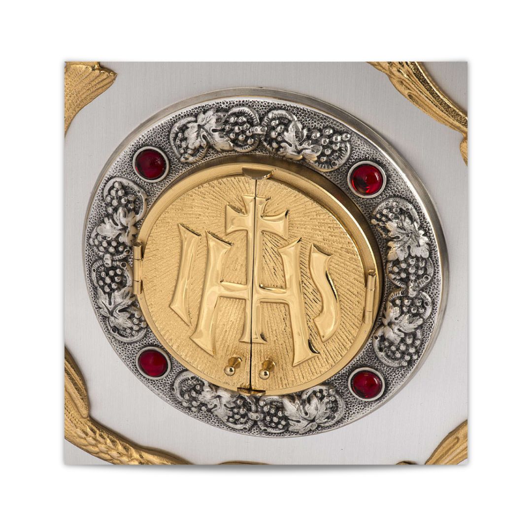 Bronze wall tabernacle IHS with a silver finish and red stones and adoration window. Made in Italy and sold by The Clergy Store