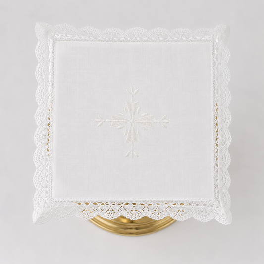 Square Italian linen chalice pall with a centered embroidered cross and crisp lace border.