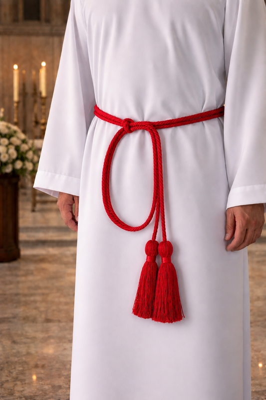 Red cincture with tassels on a white liturgical alb