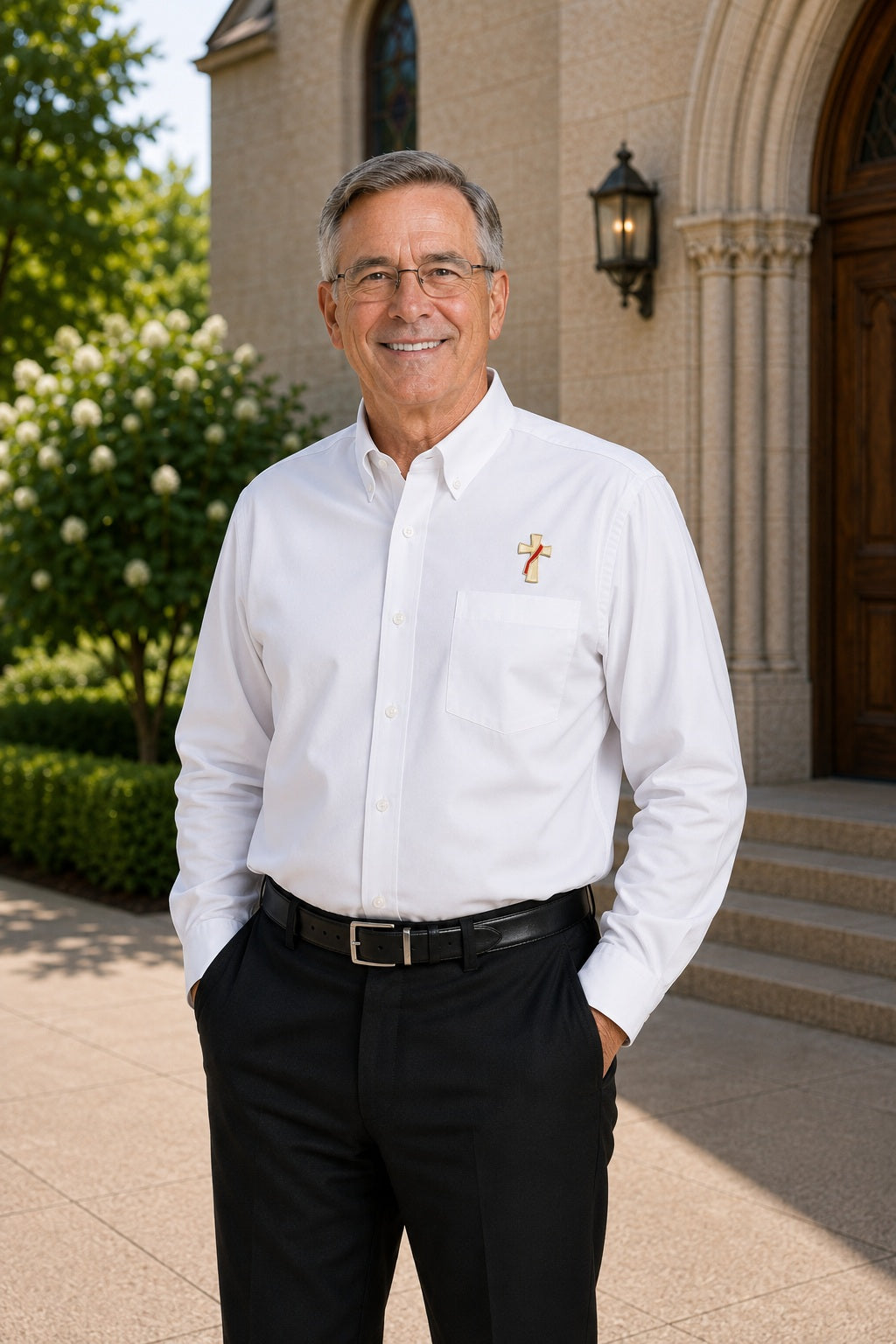 Deacon wearing a long sleeve white shirt with an embroidered symbol of a deacons cross on his left chest.