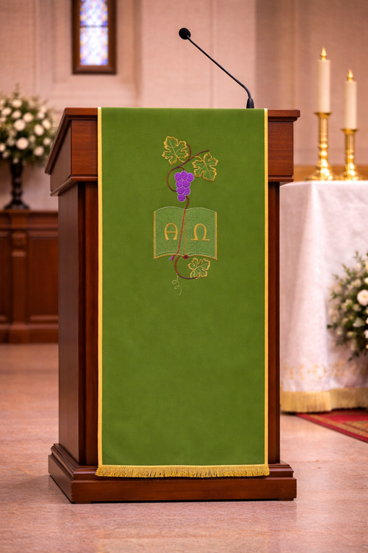 Green liturgical lectern cover with Alpha and Omega embroidery, grapevine design, and gold trim for church ambo or pulpit.