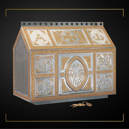 Delicate chest-type tabernacle, with filigree celtic ornamentation matching our “Tassilo” chalice.
 Rich ornamented interior in 24 karat Gold Plate. 19 1/2” High x 24” Wide x 11 1/2” Deep.Single door opening: 8 3/4” High by 8 3/4” Wide. Sold by The Clergy Store