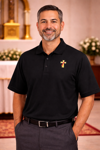 Man wearing a black polo shirt with a deacon logo.