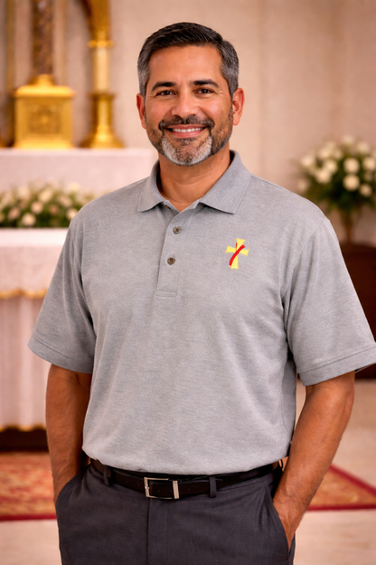 Man wearing a gray polo shirt with a deacon logo.