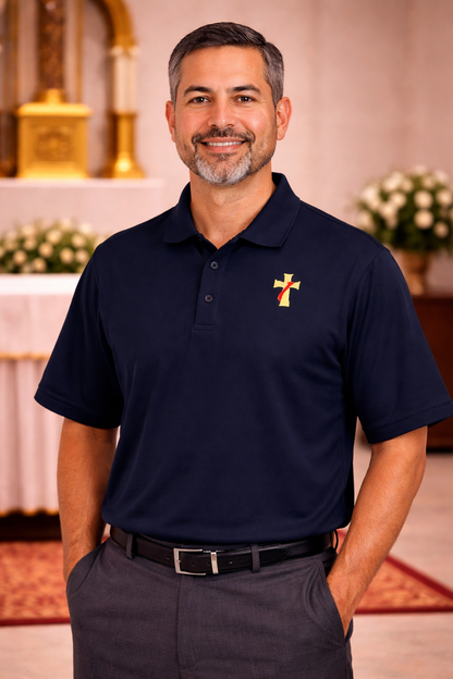 Man wearing a navy polo shirt with a deacon logo. 