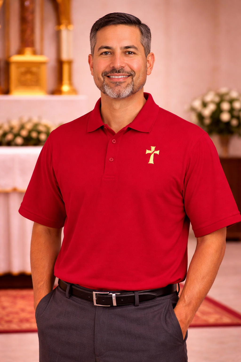 Man wearing a red polo shirt with a deacon logo.