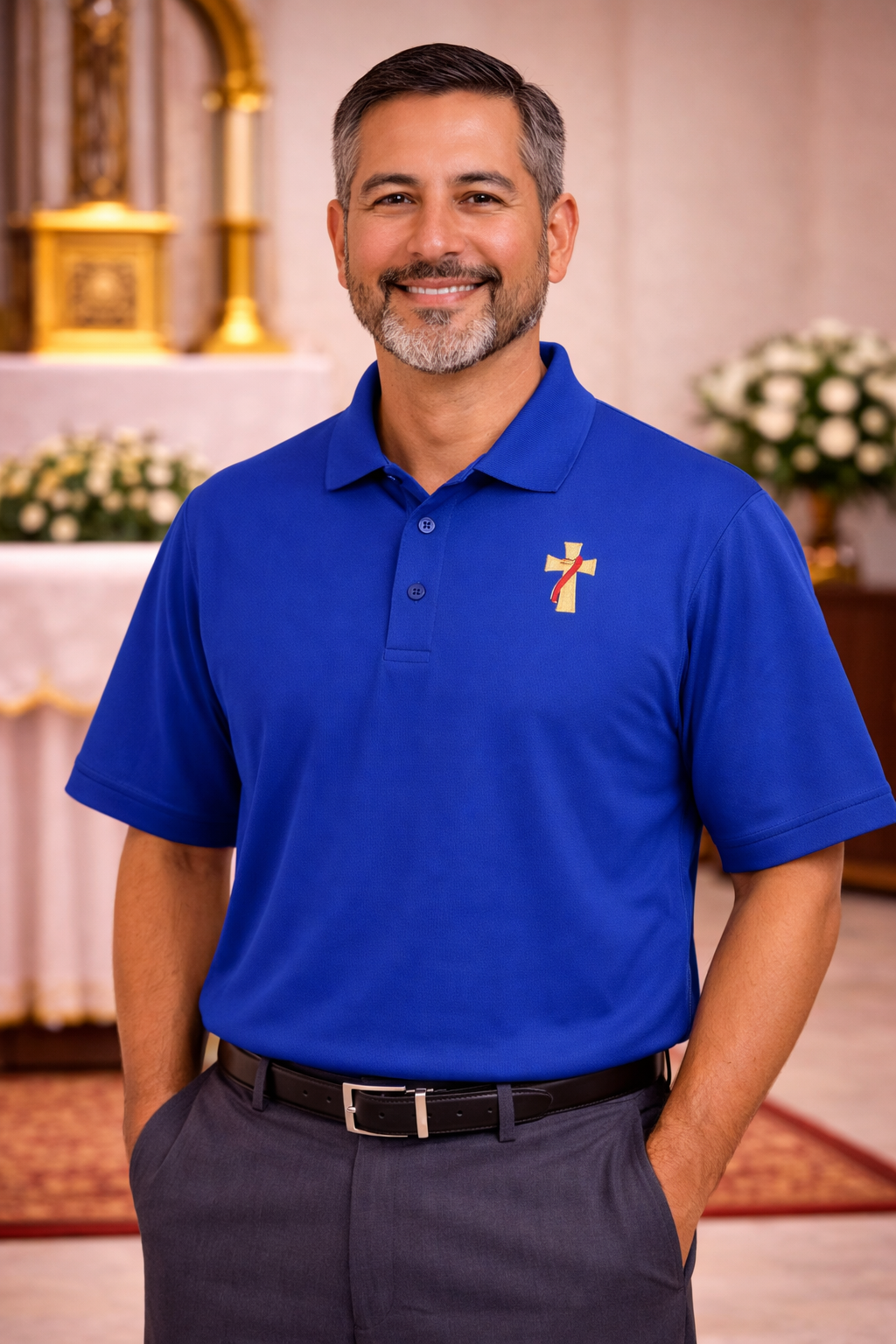Man wearing a blue polo shirt with a deacon logo.