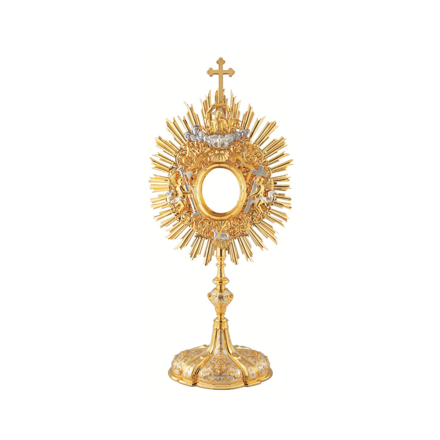 Baroque monstrance made of brass, 24-karat gold plated with silver plated accents. The glory consists of a sunburst topped with a cross and a decorative layer of floral ornaments around the luna case. God the Father and the Holy Spirit are placed at the top of the glory, while the Lamb of God is placed at the bottom. On either side of the luna case there is an angel figure. Both the node and the oval base richly adorned with floral ornaments and images of angels. The monstrance is coated with a protective l