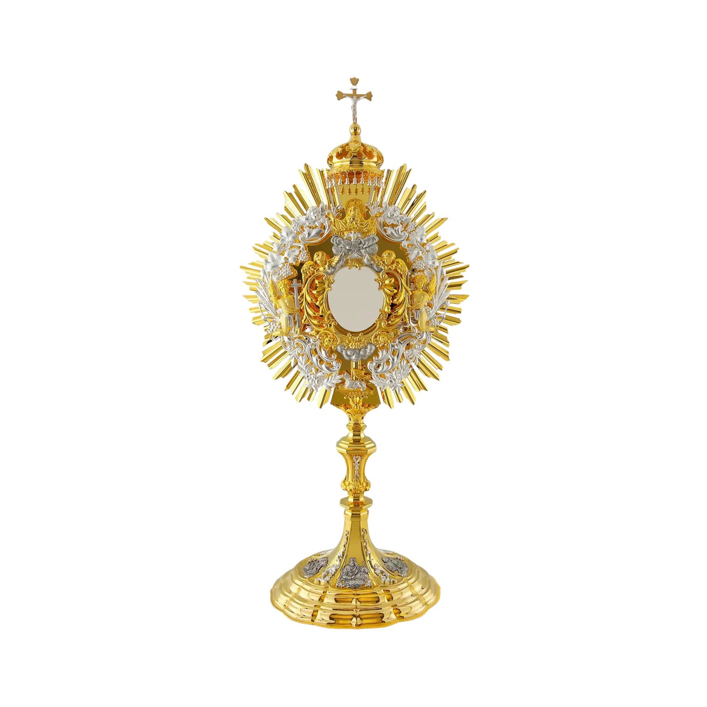 Baroque brass monstrance, gold-plated with silver-plated detailing. The central part consists of a sunburst and a silver-plated wreath of wheat and grapevine. At the top of the opening for the luna there is an image of God the Father and the Dove (the Holy Spirit). The Lamb of God is attached to the bottom of the glory. Several angel figures surround the luna case. The monstrance is topped with a canopy and a crucifix with a silver-plated figure of Jesus. The base is embellished with silver-plated and oxidi